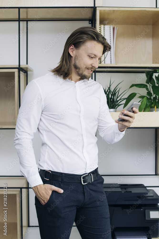 Businessman using mobile phone in the office Businessman using mobile phone in the office