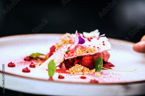 Modern food stylist decorating meal for presentation in restaurant. Closeup of food stylish. Restaurant serving