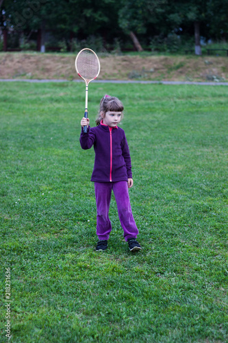 ittle girl with a racket at the stadium