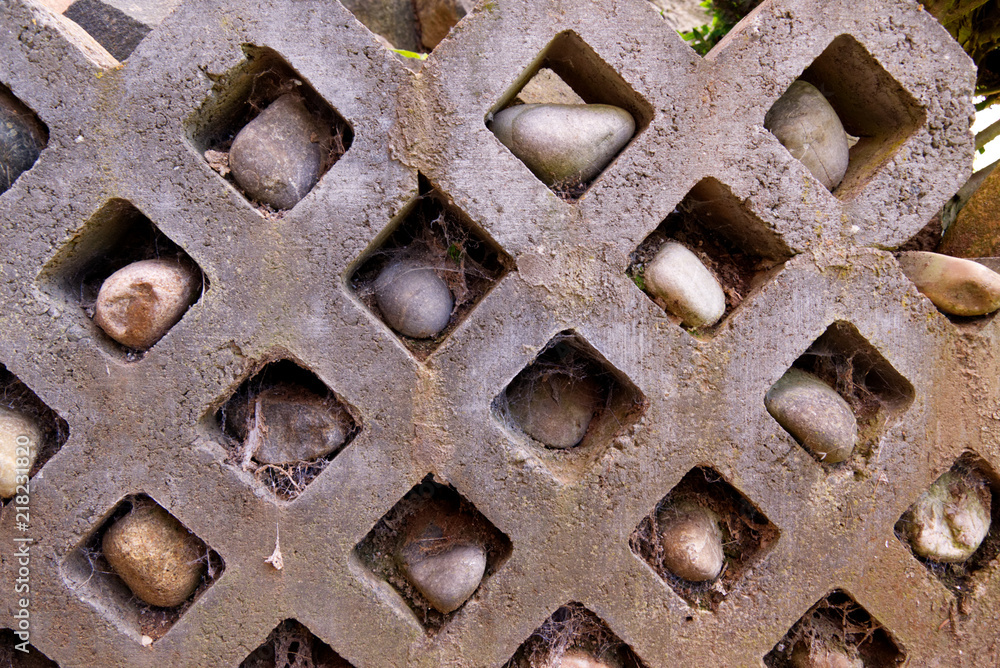 Stone wall with rocks in holes and spiderwebs - Garden Stone wall with rocks in holes and spiderwebs - Garden
