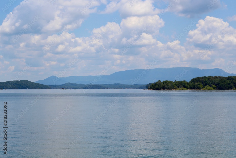 A mostly cloudy day at the lake in the mountains of smokies.