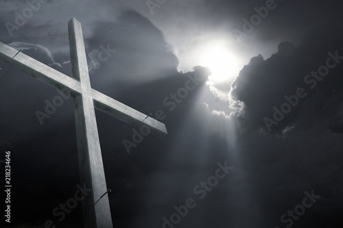 Fototapeta Dramatic religious photo illustration of a tall wooden cross faded into the background of a breaking storm