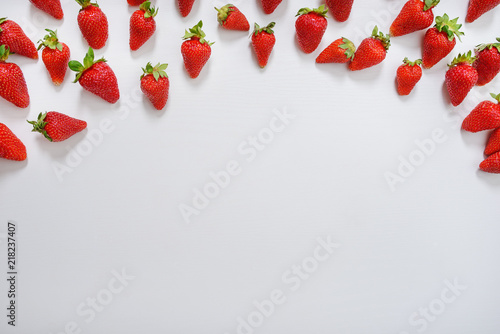 strawberry fruits on the above side on wooden background with copy space. View from above.