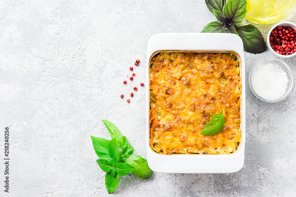 Fotografie Cheesy stuffed cabbage casserole on concrete background