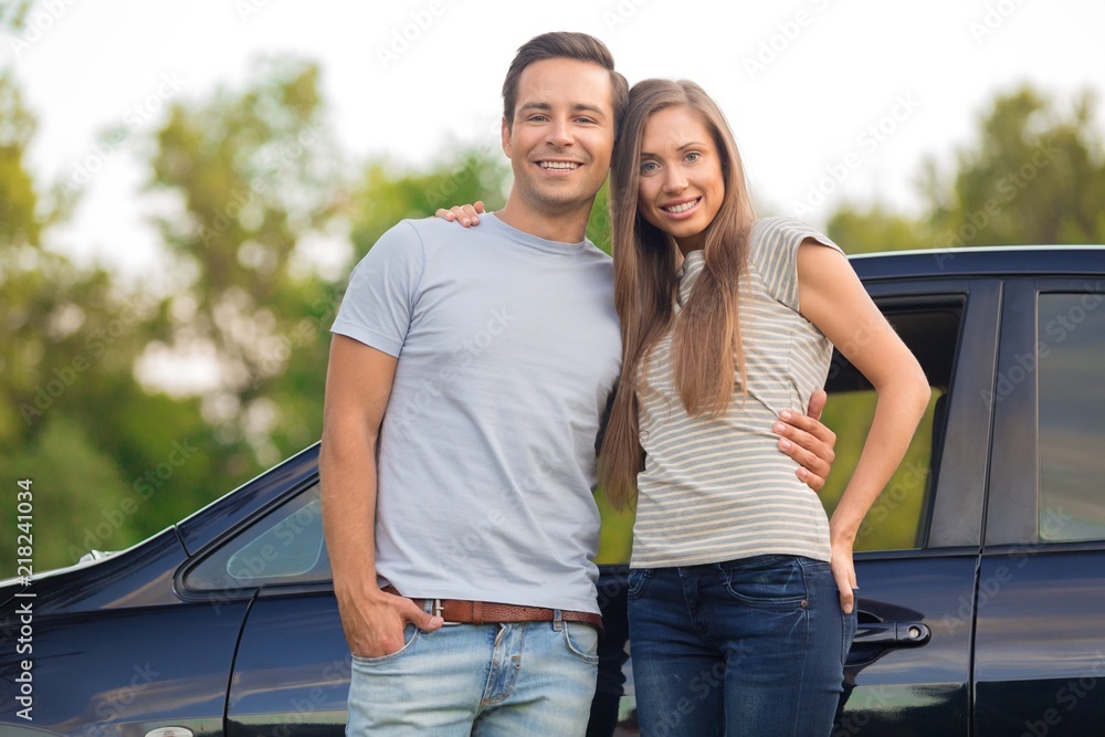 Obraz premium Portrait of a Smiling Couple by Car