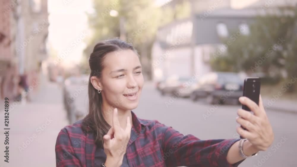 Beautiful girl doing selfie while walking around the city. Beautiful girl doing selfie while walking around the city.