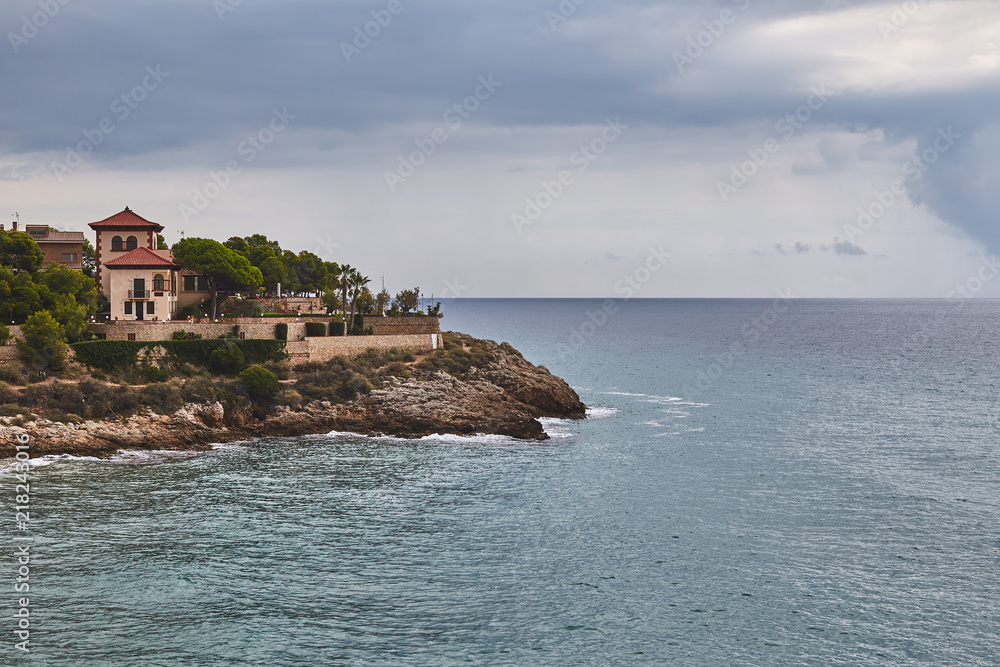 Landscape of dramatic sea cliff with building Tarragona Spain