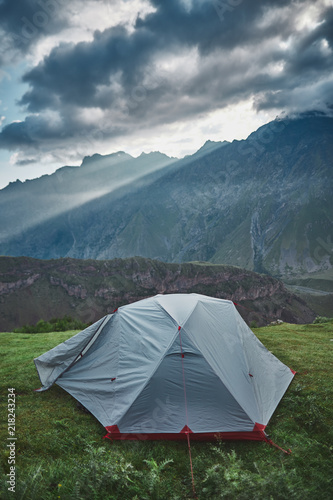 tent standing in front mountain view at the morning with god rays