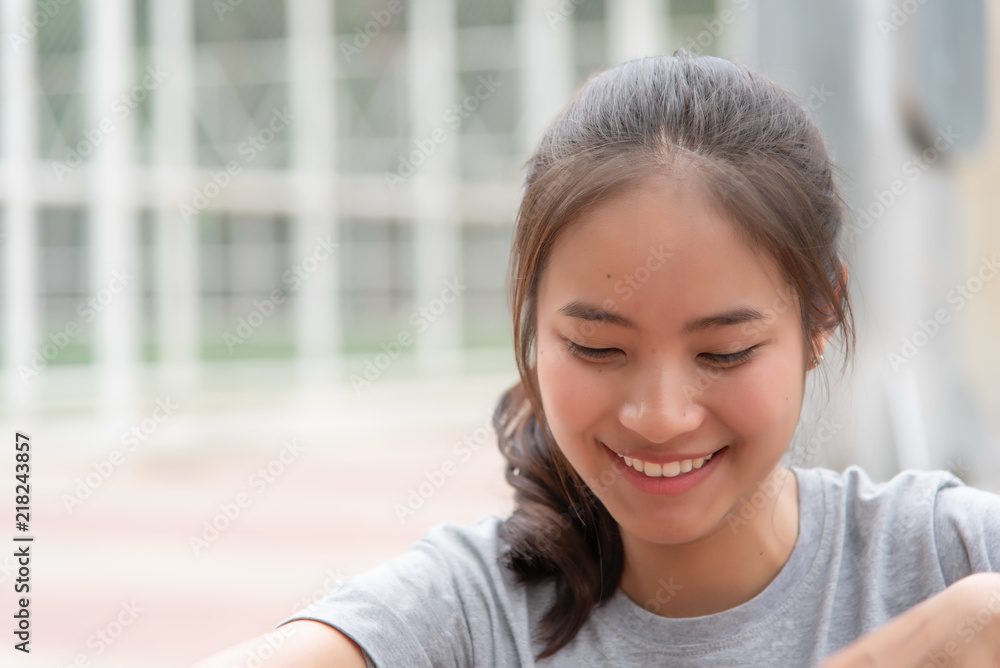 Asian female athlete who has good skin smiling happily after exercise.