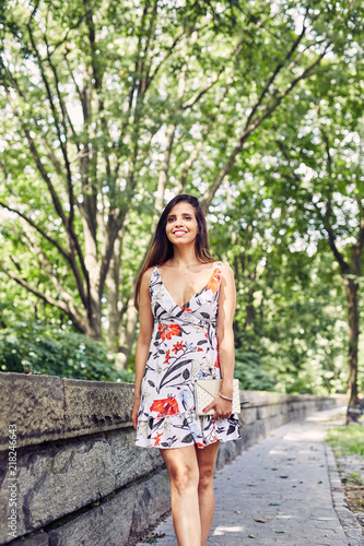 Beautiful Woman Walks down the Side Walk