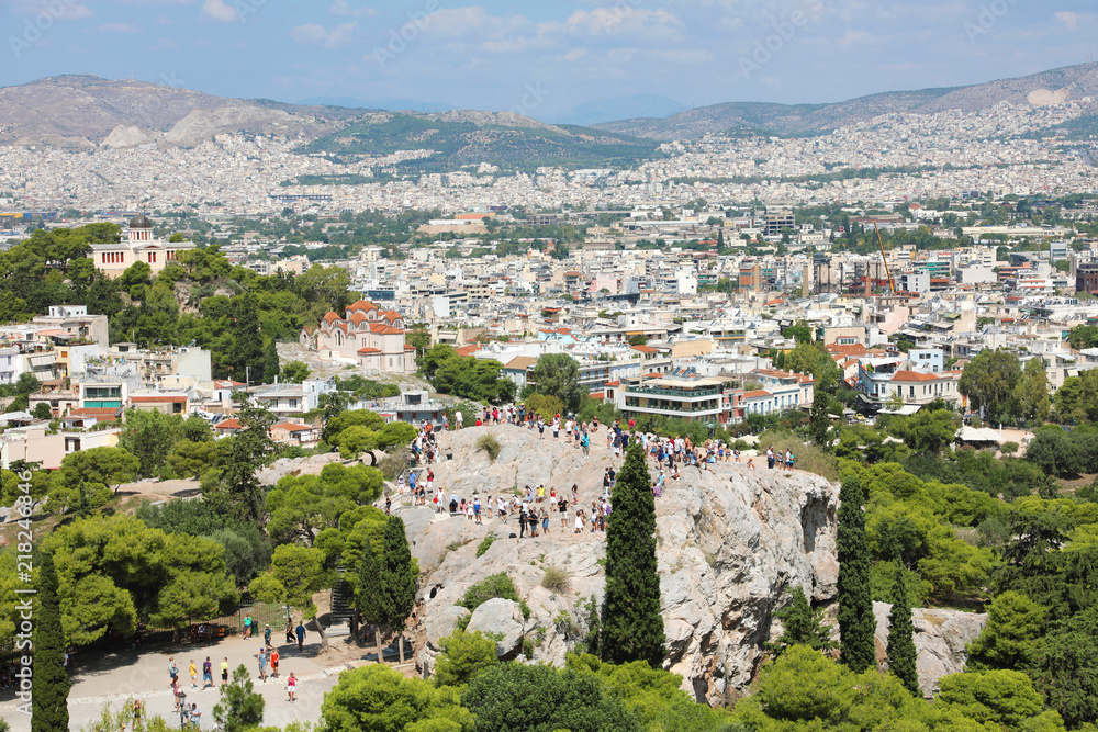 Areopagus rock with tourists and Athens Cityscape from the Acropolis, Greece