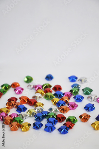 colourful bright foil paper origami stars on a white background