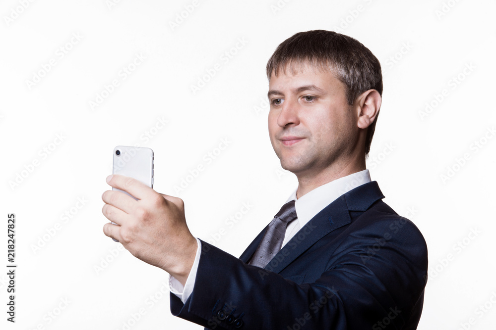 Portrait of a happy businessman in eyeglasses using smartphone over white background. Portrait of a happy businessman in eyeglasses using smartphone over white background.