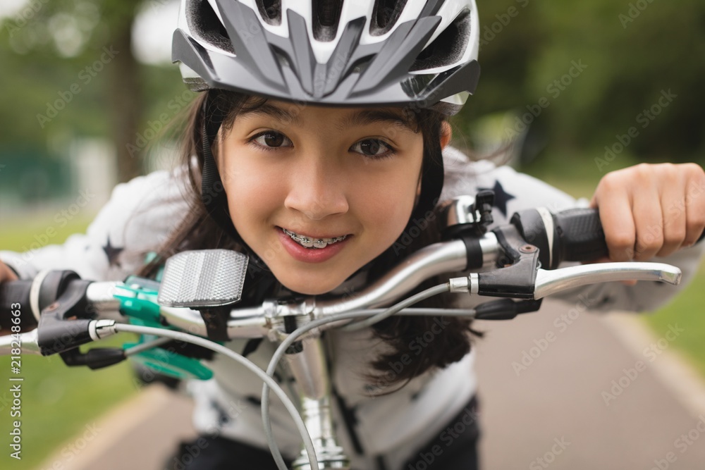 Portrait of girl riding bicycle on road Portrait of girl riding bicycle on road