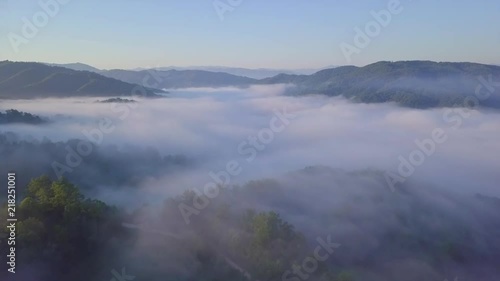Wallpaper Mural Sunrise aerial shot of mountains covered in clouds Torontodigital.ca