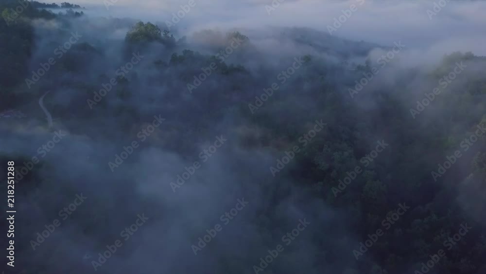 Sunrise aerial shot of mountains covered in clouds Sunrise aerial shot of mountains covered in clouds