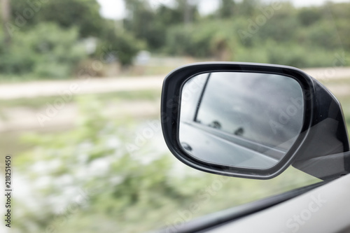 Side Mirror a car, reflection of traffic flow in left side rear view mirror 