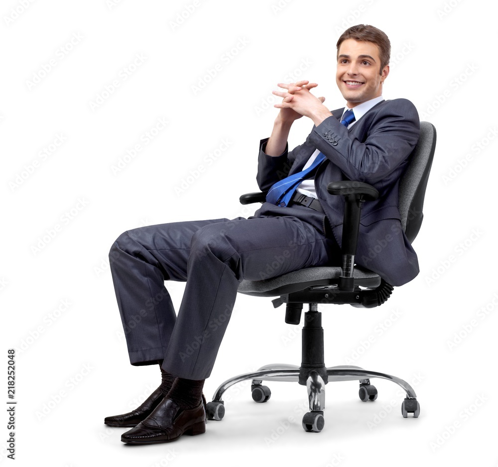 Businessman Sitting on Office Chair and Smiliing Businessman Sitting on Office Chair and Smiliing