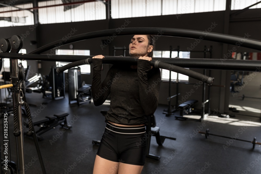 Woman exercising in fitness gym Woman exercising in fitness gym