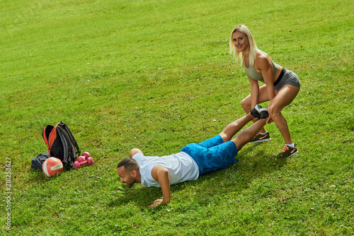 Sports multinational family; wife and husband doing sport exercises together outdoor