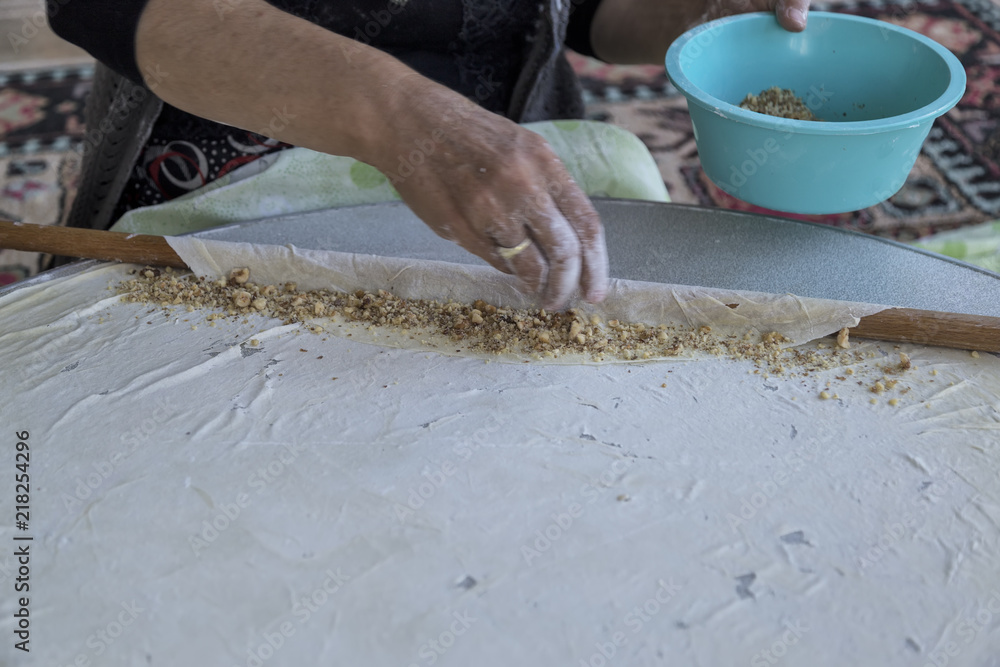 village woman making traditional turkish baklava .