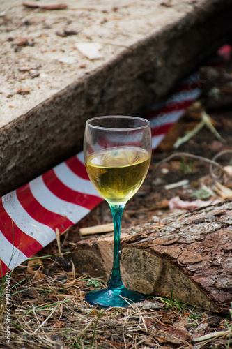 a glass of white wine and red tape