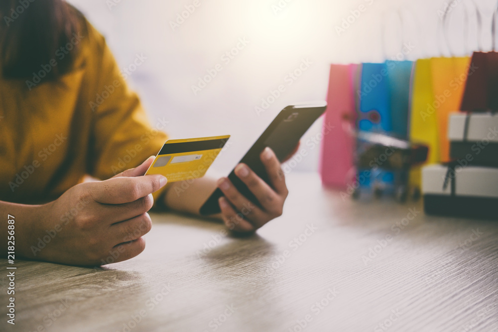 Image of Young woman using smartphone for online shopping website and pay by credit card, Online payment and shopping concept Image of Young woman using smartphone for online shopping website and pay by credit card, Online payment and shopping concept