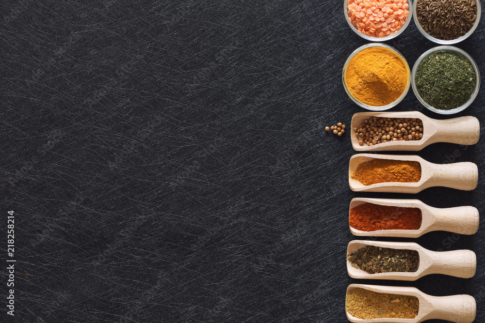 Herbs, spices and food additives on a dark background with an empty place Herbs, spices and food additives on a dark background with an empty place