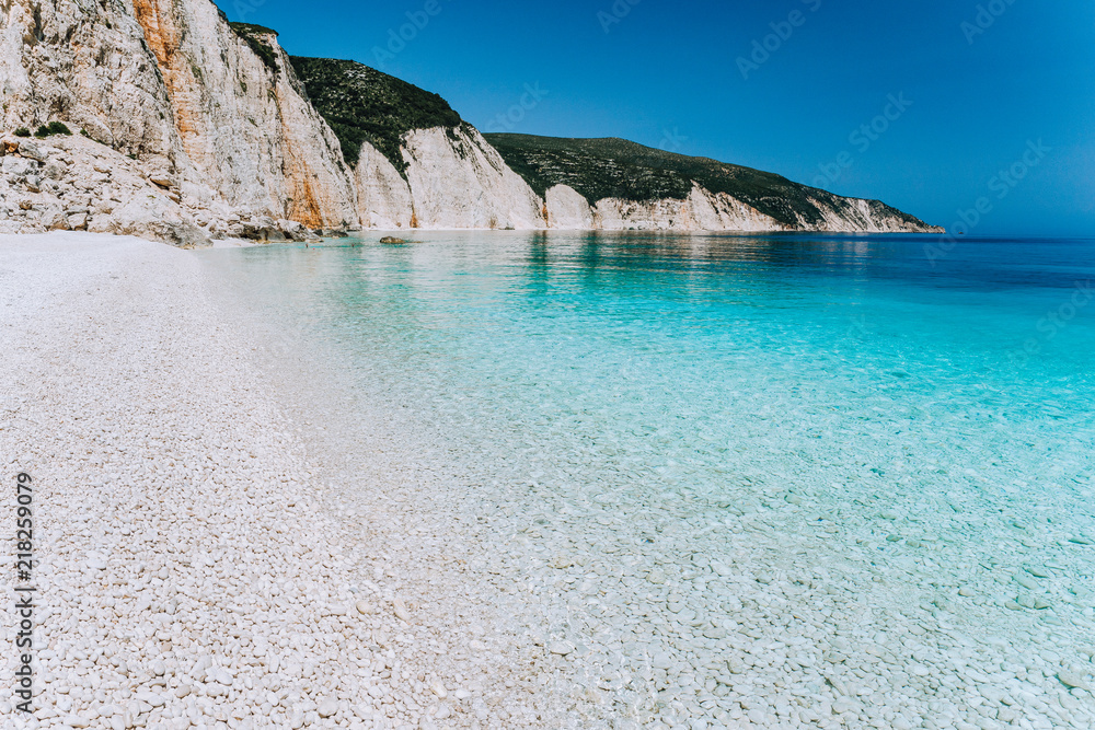 Fteri beach in Kefalonia Island, Greece. Most beautiful beach with pure azure emerald sea water surrounded by high white rocky cliffs