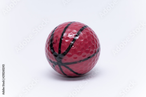 Golfball painted like a basketball ball golf ball