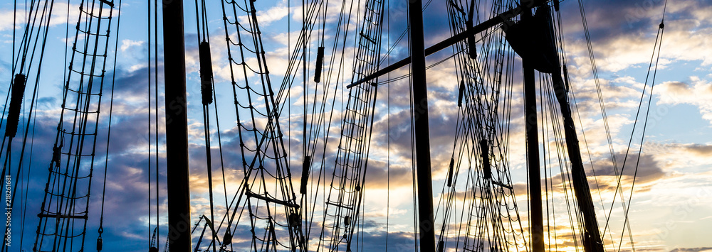 Mast and rope sailboat vessel on sky sunset background