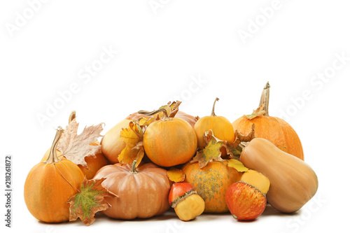 Orange pumpkins with dry leafs isolated on a white background