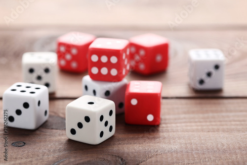 Colourful dice on brown wooden table