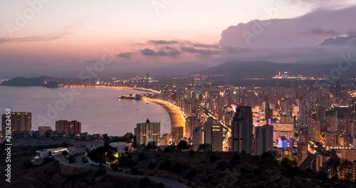 High angle view timelapse of dusk to night falling over Benidorm bay and city. Costa blanca, Spain photo