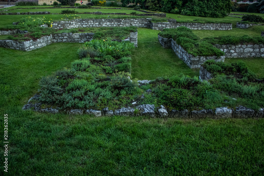 ancient destroyed stones ruins on grass background texture with empty space for copy or text ancient destroyed stones ruins on grass background texture with empty space for copy or text