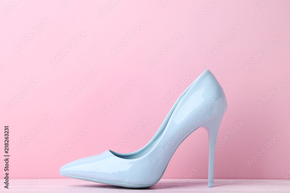 Blue high heel shoes on pink background Blue high heel shoes on pink background