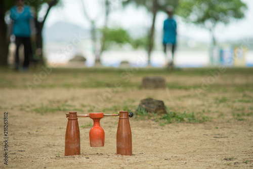 brown woodball gate or finish line on sand ground floor. famous sport for thai elder photo