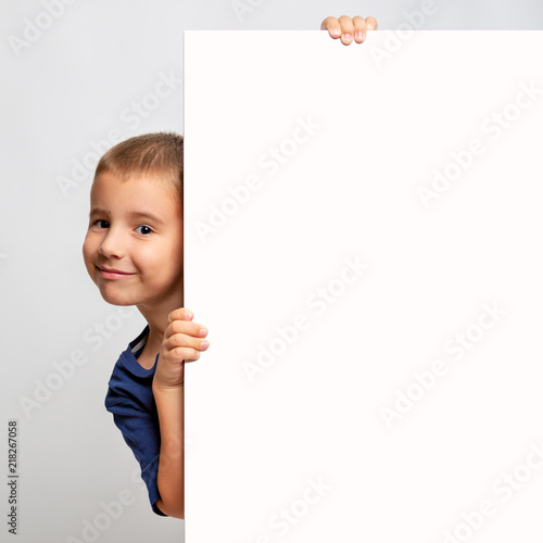 White billboard with smiling child on the side