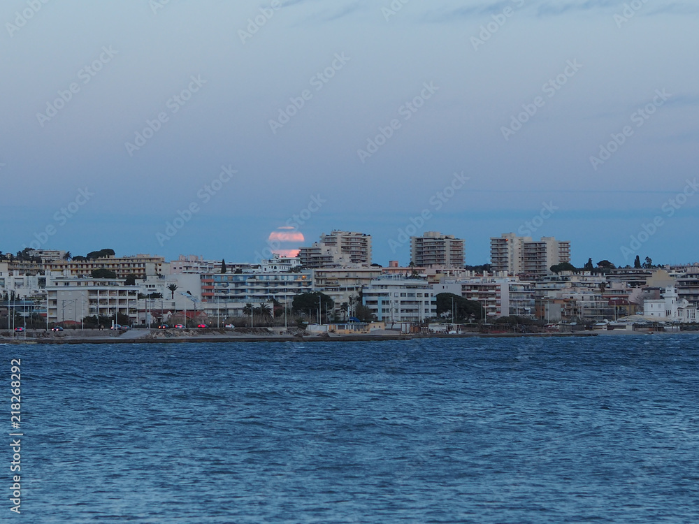 Super Moon behind cityscape in French Riviera
