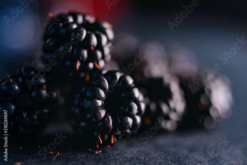 Fresh blackberries, close-ups on a dark background.