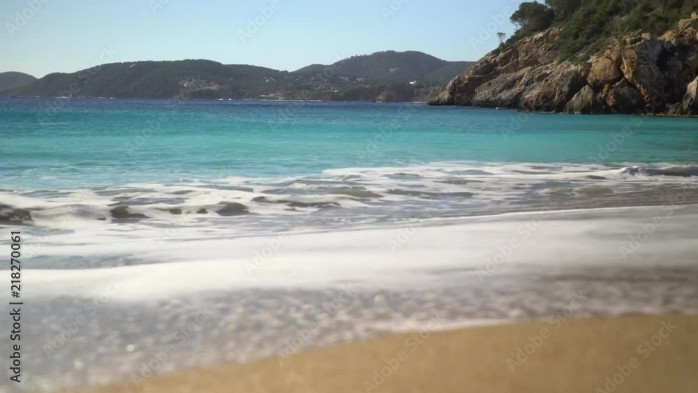 Aqua perfect Calm Waves on the beach with an white sand beach. Ibiza. Low angle. Aqua perfect Calm Waves on the beach with an white sand beach. Ibiza. Low angle.