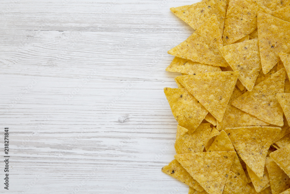 Tortilla chips on white wooden table, top view. Mexican food. Copy space. Tortilla chips on white wooden table, top view. Mexican food. Copy space.
