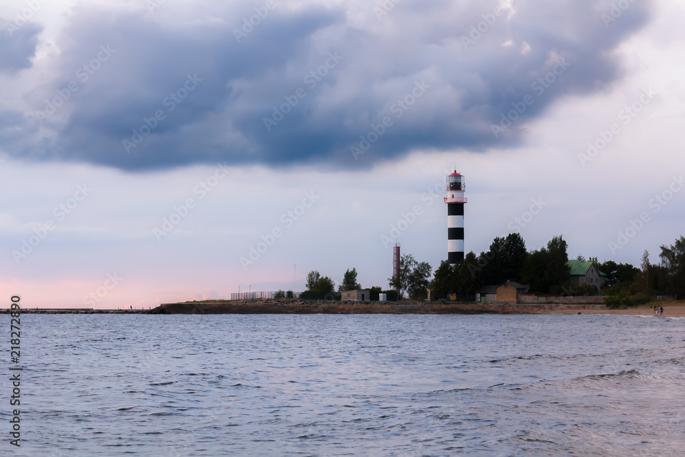 Lighthouse at the entrance to the port of Riga in the evening, in August