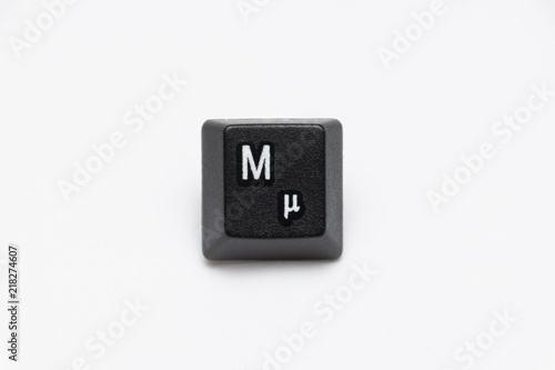Single black keys of keyboard with different letters M