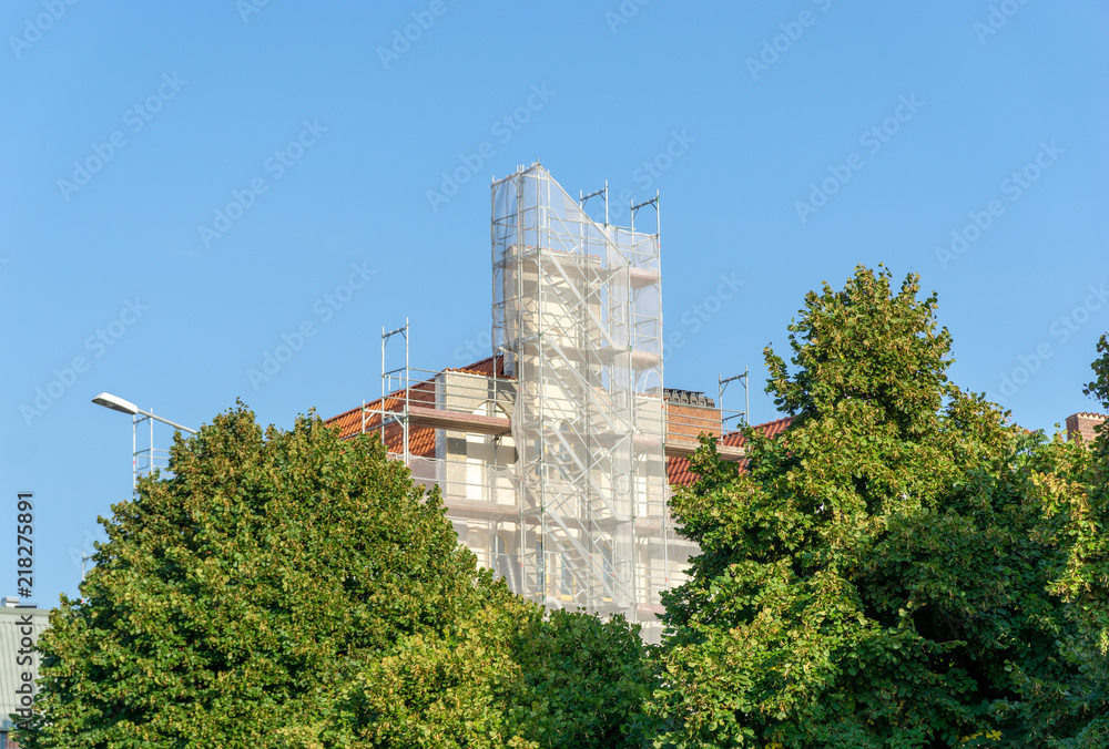 house with scaffolding on the outside wall