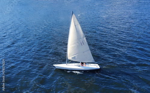 Aerial. Nautical sailling of a catboat yacht.