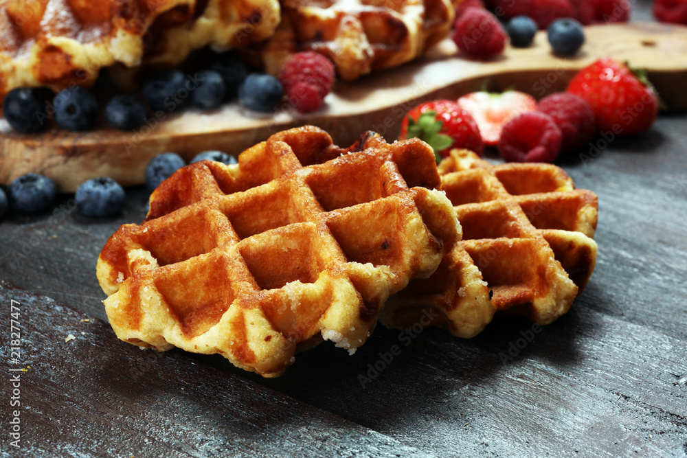 Traditional belgian waffles with fresh mint, sugar and raspberries. Traditional belgian waffles with fresh mint, sugar and raspberries.