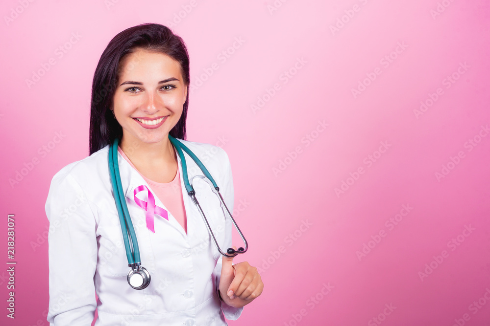 beautiful girl doctor, nurse and surgeon with breast cancer prevent concept on the pink background Support for onco patients beautiful girl doctor, nurse and surgeon with breast cancer prevent concept on the pink background Support for onco patients