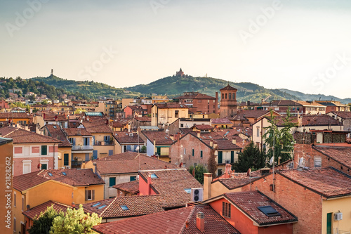 Bologna, Emilia Romagna, Italy. The roofs of city at sunset: Basilica of San Luca on the background. photo