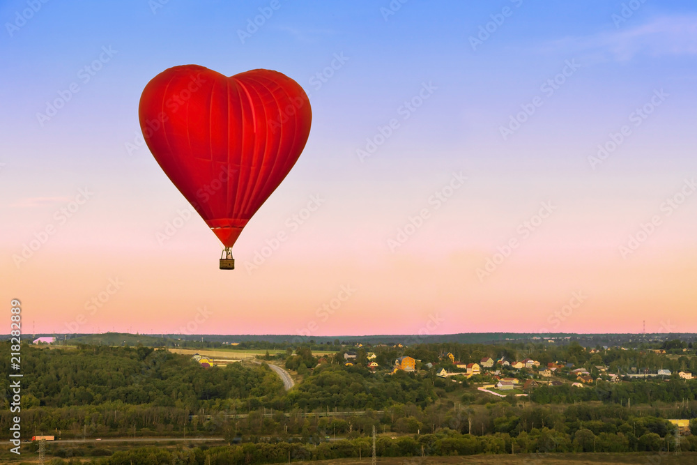 Heart flying red hot air balloon in sunset blue pink sky with a copy ...